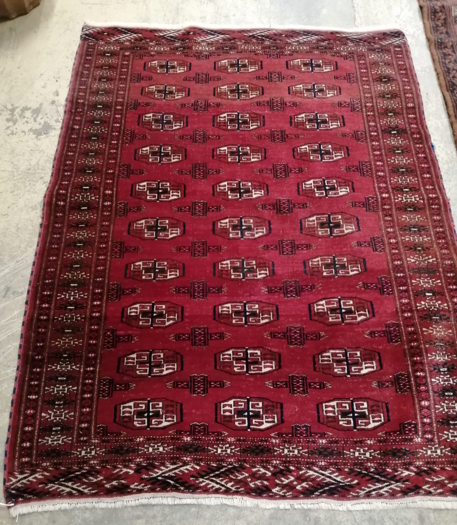 A Bokhara red ground rug, woven with rows of boteh, 160 x 120cm